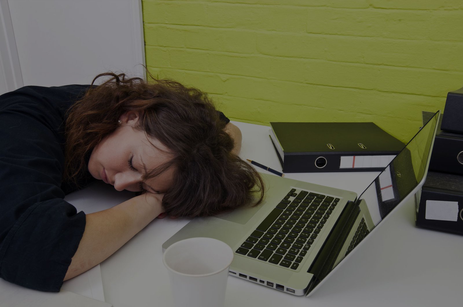 Narcolepsy Research Study FutureSearch Trials Austin Texas. Woman sleeping at her work desk during the day.